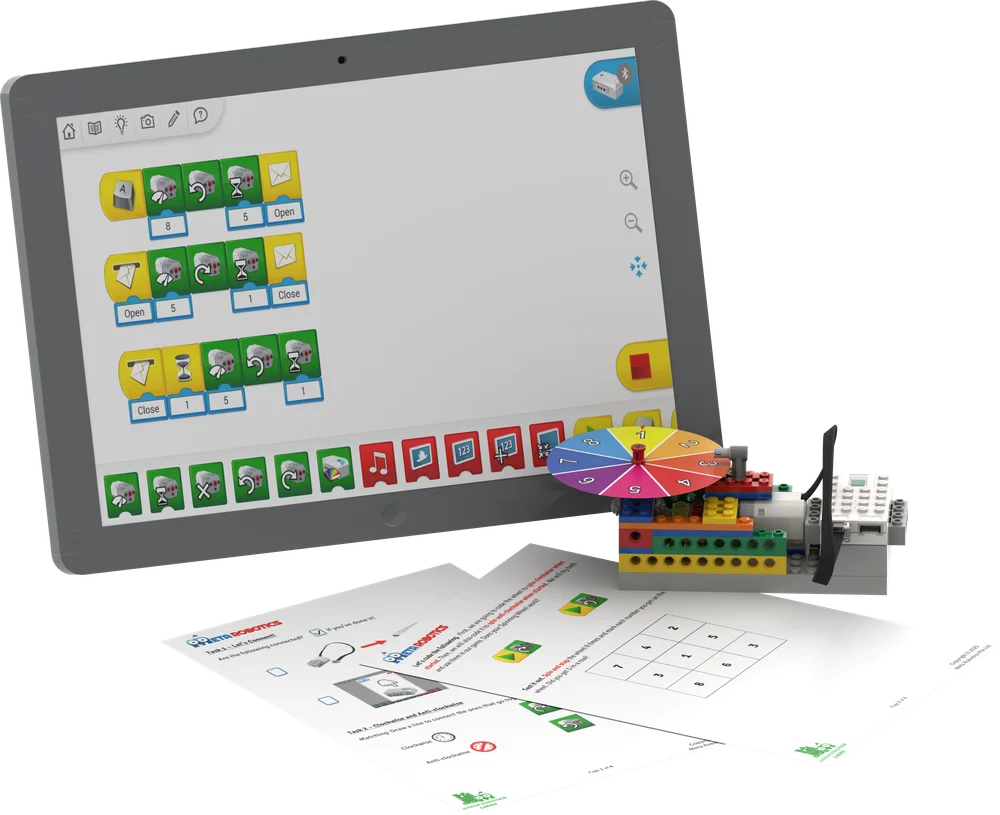 Spin the Wheel lesson: WeDo 2.0 icon code on a tablet, the spinning-wheel model and student worksheets